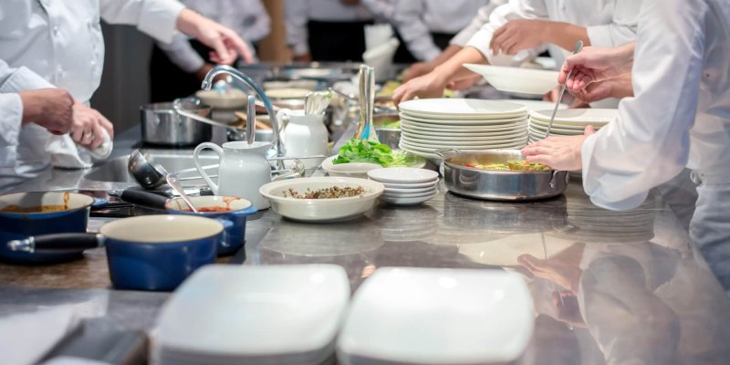 Team of restaurant chef helping each other to finish the good food for customer in five star hotel